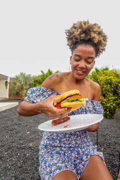 Young African American woman enjoying a BBQ outdoors