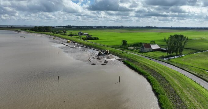 Aerial footage of the process of maintenance on dikes and strengthen protection in The Netherlands