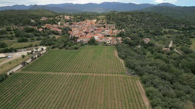 Aerial drone images of Rabos, a small medieval town in the mountains of Catalonia in Spain, surrounded by green vineyards