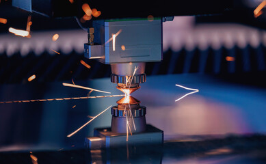 Laser CNC cut of metal with light spark. Blue color background banner, technology modern industrial