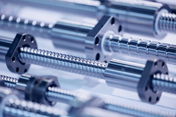 Metal guides with large threads for CNC machine drive. Industrial background blue toning, concept fix service