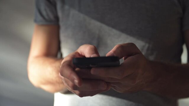 Man using modern smartphone portable information device to type text message