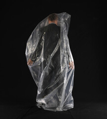 MAN businessman in a plastic bag on a black background