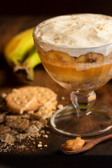 Decadent Banoffee Pudding with Whipped Cream and Cookies. A layered tropical treat: This homemade banoffee pudding is an explosion of flavors and textures, with soft bananas, rich caramel
