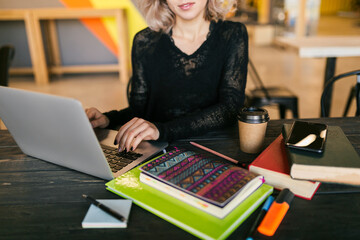Fototapeta premium young woman working on laptop in co-working office