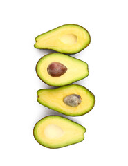 Halves of tasty ripe avocados on white background