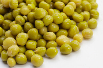 Canned green peas on white background.