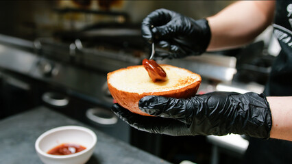 Spreading The Sauce On The Burger Bun