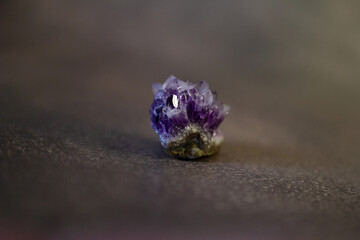 Violet amethyst quartz crystal on black background