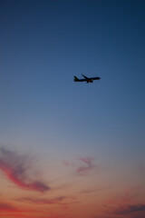 Airplane silhouetted against a beautiful sunset sky.  © Yana Gavriloski
