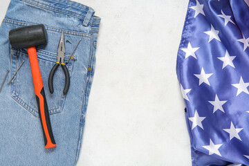 Jeans with tools and USA flag on white background. Labor Day celebration