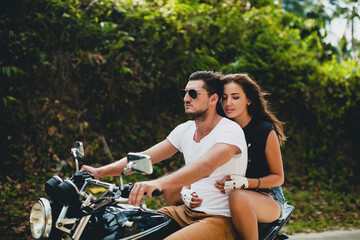 Obraz premium young couple in love, riding a motorcycle, hug, passion, free spirit