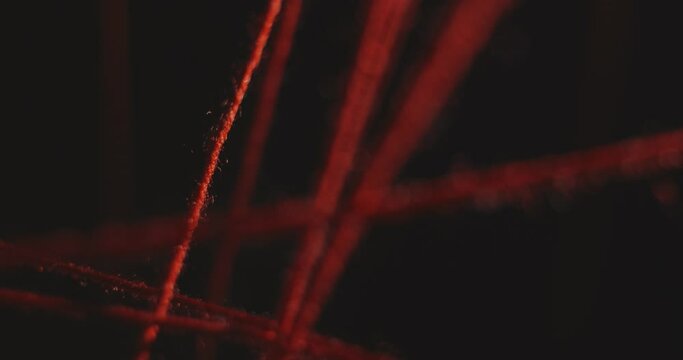 Movement between the taut red threads of the intricacies of the plot