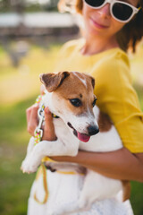 young stylish hipster woman holding walking playing dog puppy jack russell