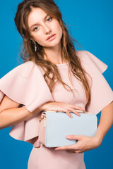 Fototapeta premium young stylish sexy woman in pink luxury dress, summer fashion trend holding trendy handbag