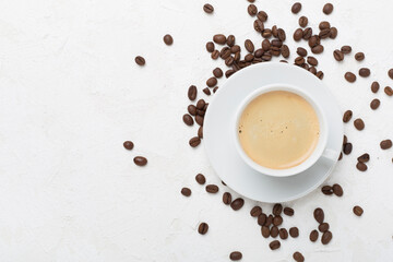 Cup of coffee on concrete background, top view