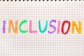 Colorful word INCLUSION written on page of notebook