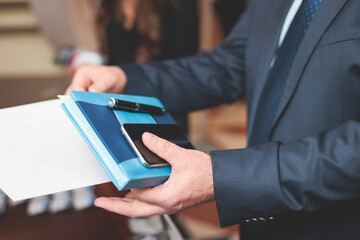 Process of checking in on a conference congress forum event, registration desk table, visitors and attendees receiving a name badge and entrance wristband bracelet and register electronic ticket