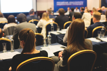Female participants audience at the symposyum meeting, attendees in conference room hall listens to...