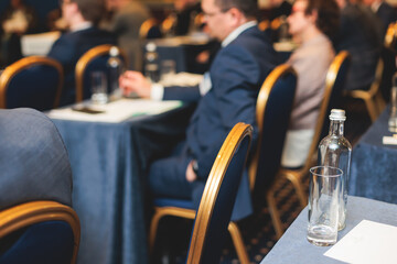 Audience at the modern conference hall listens to lecturer, people on a congress together listen to speaker on stage at master-class, corporate business seminar, venue for a congress forum event