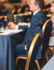 Audience at the modern conference hall listens to lecturer, people on a congress together listen to...