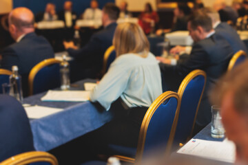 Audience at the modern conference hall listens to lecturer, people on a congress together listen to...