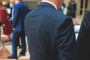 Group of men in business suits talking and discussing during coffee break at conference, politicians and entrepreneurs networking and negotiate, businessmen have a conversation dialog on a forum