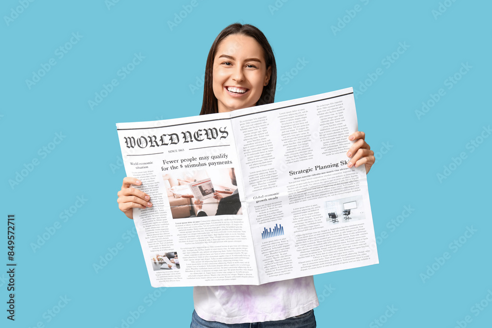 Canvas Prints beautiful young woman with newspaper on blue background