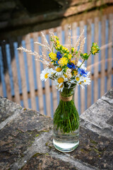 Flowers in a vase by the garden pool © JiriD