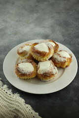 eclairs with vla or custard filling served on a plate