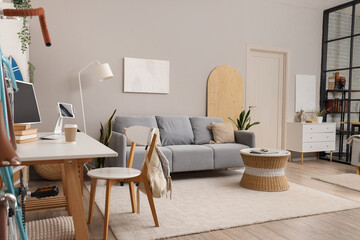 Interior of living room with sofa and student's table