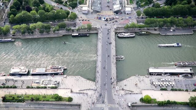 Many pedestrians and cars seen from above on Iena bridge over the river Seine in Paris, France.
