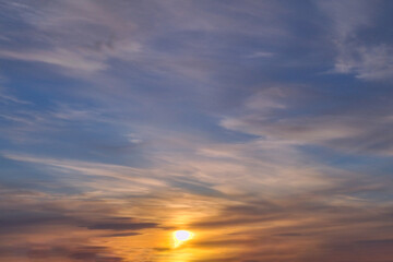Summer evening sky in the picturesque clouds, lit by the rays of the setting sun.