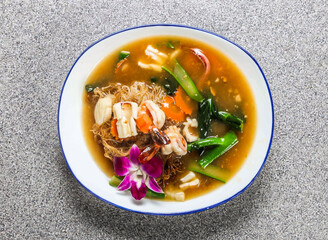 Wet Fried Seafood Rice Noodles with cucumber and coriander served in plate isolated on grey background top view of hong kong fastfood