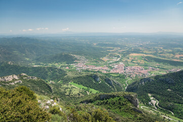 Obraz premium Panoramic view of the Mirador de la Figuerassa, Berguedà, Catalonia, Spain. Baells reservoir, Catllaras and Picacel mountains. City of Berga in the middle of a forest. Barcelona province, Cercs.
