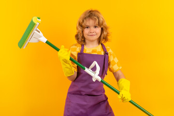 Child helping to clean. Child mopping house, cleaning home. Detergents and cleaning accessories....