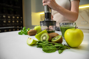 Fresh fruits on the table with immersion blender and smoothie