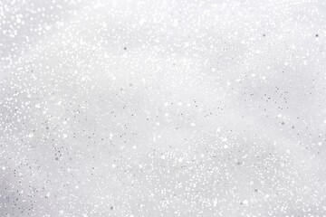 Obraz premium Silver white glitter sparkle confetti background for Christmas snow, New Year, Birthday, anniversary celebration wallpaper with copyspace