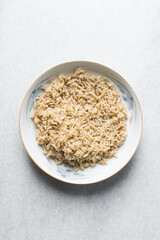 Overhead view of cooked basmati rice in a white ceramic plate, top view of steamed basmati rice in a white bowl