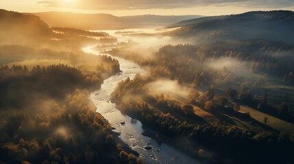 An aerial shot captures a mist-wrapped meandering river flowing through a lush, autumnal landscape at dawn.