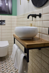 Modern Bathroom with Ceramic Basin, Wooden Countertop, and Wall-Mounted Fixtures