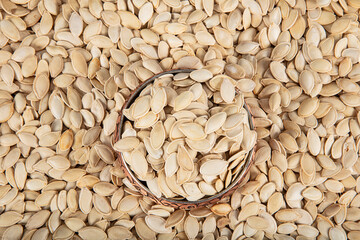 Many pumpkin seeds as background. Dried pumpkin seeds. Detail of pumpkin seeds background. food...