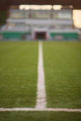 A green soccer field featuring white line markings for soccer games and competitions