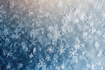Scattering of delicate white snowflakes are laying on a blue and grey surface, creating a beautiful winter background