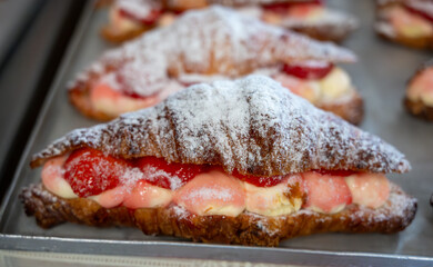 French cuisine, fresh baked strawberry croissants with cream and fresh fruits