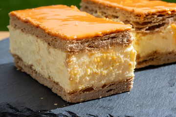 Celebration of the King birthday in Netherlands, tompoes or tompouce, iconic pastry in Netherlands made from puff dough, orange icing, cream