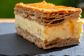 Celebration of the King birthday in Netherlands, tompoes or tompouce, iconic pastry in Netherlands made from puff dough, orange icing, cream