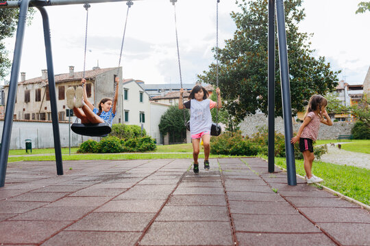 three girls playing at children playground outdoors