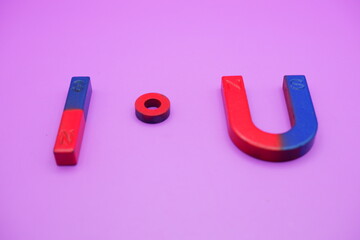 various shapes of magnets isolated on a purple background