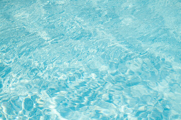 Obraz premium Blue water reflection. Blue pool waves. Swimming pool. Water surface. Blue water texture. Close up blue water surface. Textured background.